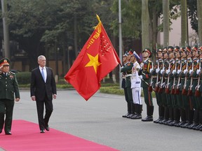 FILE - In this Jan. 25, 2018, file photo, U.S. Defense Secretary Jim Mattis and his Vietnamese counterpart Ngo Xuan Lich, left, review an honor guard in Hanoi, Vietnam. By making a rare second trip this year to Vietnam, Mattis is showing how intensively the Trump administration is trying to counter China's military assertiveness by cozying up to smaller nations in the region who share American wariness about Chinese intentions. The visit beginning Tuesday also shows how far U.S.-Vietnamese relations have advanced since the tumultuous years of the Vietnam War, whose legacy includes a continued search for the remains of U.S. war dead on Vietnamese soil.