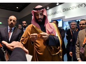 In this March 24, 2018, photo, Saudi Arabia Crown Prince Mohammed bin Salman tours an innovation gallery of Saudi Arabian technology, including an exhibit by King Abdullah University of Science and Technology, during a visit to Massachusetts Institute of Technology in Cambridge, Mass. While some U.S. colleges rethink their ties to Saudi Arabia, many more have shown no signs of backing away. An Associated Press analysis of federal data finds that 38 schools received at least $359 million from the Saudi government from 2011 through 2017.