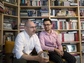 Gay rights activist Florin Buhuceanu, left, and his partner Victor Ciobotaru, a gender and political studies student, talk during an interview with the Associated Press in Bucharest, Romania, Friday, Oct. 5, 2018. Romania is holding a referendum this weekend on the definition of marriage that could outlaw same-sex marriages. It's supported by the Romanian Orthodox Church and conservative groups, but has been criticized by gay rights groups and 47 European lawmakers who say it risks discriminating against single-parent families and others.