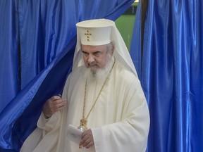 Head of the Romanian Orthodox church Patriarch Daniel exits a voting booth in Bucharest, Romania, Saturday, Oct. 6, 2018. Two days of voting on a constitutional amendment that would make it harder to legalize same-sex marriage has started in Romania.