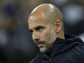 Manchester City coach Pep Guardiola enters the field for the English Premier League soccer match between Tottenham Hotspur and Manchester City at Wembley stadium in London, England, Monday, Oct. 29, 2018.