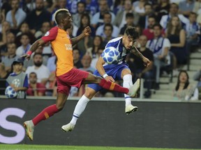 Galatasaray forward Henry Onyekuru vies for the ball with Porto defender Alex Telles, right, during the Champions League group D soccer match between FC Porto and Galatasaray at the Dragao stadium in Porto, Portugal, Wednesday, Oct. 3, 2018.