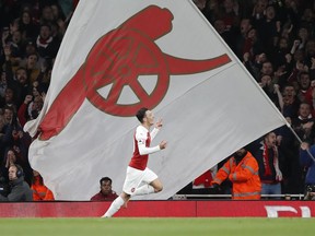 Arsenal's Mesut Ozil celebrates after scoring his side's first goal of the game during the English Premier League soccer match between Arsenal and Leicester City at the Emirates stadium in London, Monday, Oct. 22, 2018.