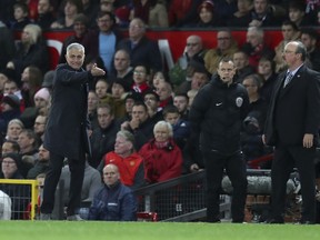 Manchester United's manager Jose Mourinho, left gestures to his players during their English Premier League soccer match between Manchester United and Newcastle United at Old Trafford in Manchester, England, Saturday, Oct. 6, 2018.