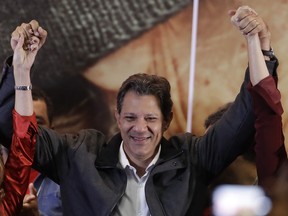 Brazil's presidential candidate for the Workers Party Fernando Haddad raises his arms as he celebrates the elections results, in Sao Paulo, Brazil, Sunday, Oct. 7, 2018. Official results showed that Haddad will face Jair Bolsonaro, the far-right congressman in a second-round vote.