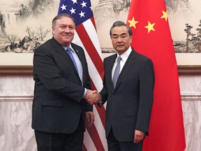 U.S. Secretary of State Mike Pompeo, left, shakes hands with Chinese Foreign Minister Wang Yi before their meeting at the Diaoyutai State Guesthouse in Beijing, Monday, Oct. 8, 2018. Pompeo said Monday that he and North Korean leader Kim Jong Un made "significant progress" toward an agreement for the North to give up its nuclear weapons. While significant work remains to be done, he said he expected further results after an as-yet unscheduled second summit between Kim and President Donald Trump.