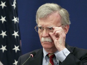 U.S. National security adviser John Bolton adjusts his glasses while speaking to the media during a news briefing following his meetings with Georgian officials in Tbilisi, Georgia, Friday, Oct. 26, 2018.