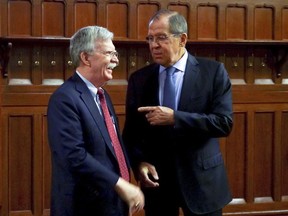 U.S. National Security Adviser John Bolton, left, and Russian Foreign Minister Sergey Lavrov talk to each other during their meeting in Moscow, Russia, Monday, Oct. 22, 2018. U.S. President Donald Trump's national security adviser has met with top Russian officials after Trump declared he intended to pull out of a 1987 nuclear weapons treaty. (Russian Foreign Ministry Press Service via AP)