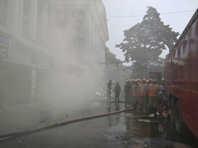 Firefighters work to control a fire at Calcutta Medical College and Hospital in Kolkata, India, Wednesday, Oct. 3, 2018. A fire broke out in a pharmacy at a state-run medical college and hospital complex in eastern India, causing panic among nearly 250 patients who have been evacuated to safe wards. No casualties have been reported.