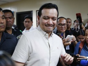 Opposition Senator Antonio Trillanes IV smiles shortly after addressing reporters outside his Philippine Senate office after a regional trial court judge issued a ruling denying the Justice Department's request for an arrest warrant against him Monday, Oct. 22, 2018 in suburban Pasay city south of Manila, Philippines. Trillanes, one of the fiercest critics of President Rodrigo Duterte, holed himself up at the Senate after Duterte voided his amnesty application for a 2003 coup attempt.