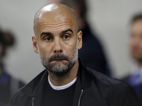 Manchester City coach Pep Guardiola reacts during the group F Champions League soccer match between Hoffenheim and Manchester City at the Rhein-Neckar-Arena stadium in Sinsheim, Germany, Tuesday, Oct. 2, 2018.