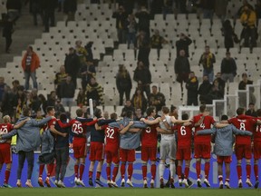 Bayern players greet supporters at the end of a Group E Champions League soccer match between AEK Athens and Bayern Munich at the Olympic Stadium in Athens, Tuesday, Oct. 23, 2018.