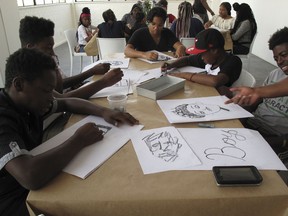 Students from the Ember Charter School in Brooklyn, N.Y. draw during an art workshop in Johannesburg on Sept. 29, 2018. Dozens of students from a Brooklyn charter school are visiting South Africa to explore African cultures and South Africa's journey from racial tension to reconciliation.