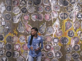 A woman attends the opening of an exhibition of South African abstract artist Christo Coetzee, who died in 2000 and is largely unknown in his home country, on Thursday, Oct. 4, 2018. The retrospective show at the Standard Bank Gallery in Johannesburg aims to stoke interest in Coetzee, who won some international acclaim decades ago.