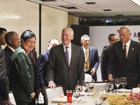 U.S. Defense Secretary Jim Mattis, center, and Singapore's Defense Minister Ng Eng Hen, front right,  attend an informal lunch meeting with defense ministers at ASEAN Defense Ministers' Meeting in Singapore Friday, Oct. 19, 2018.