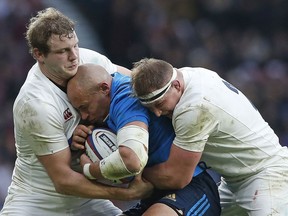 FILE - In this Sunday, Feb. 26, 2017 file photo, Italy's Sergio Parisse, center, is tackled by England's Joe Launchbury, left, and Dylan Hartley during the Six Nations rugby union match between England and Italy at Twickenham stadium in London. With the World Cup less than a year away, Italy captain Sergio Parisse knows that the November tests have an added significance for everyone. The Azzurri travel to the United States to play Ireland in Chicago on Oct. 3, before returning to Italy for matches against Georgia, Australia and New Zealand. Despite playing against two of the southern hemisphere's biggest sides, Parisse insists the players only have victory on their minds.