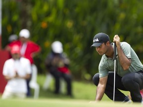 Shubhankar Sharma of India lines up a putt on the ninth hole during third round of the CIMB Classic golf tournament at Tournament Players Club (TPC) in Kuala Lumpur, Malaysia, Saturday, Oct. 13, 2018.