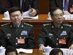 FILE - In this March 8, 2017, photo, Zhang Yang, left, the then-head of China's People's Liberation Army (PLA) political affairs department and Fang Fenghui, right, the then-chief of the general staff of the Chinese People's Liberation Army attend China's National People's Congress (NPC) at the Great Hall of the People in Beijing. China's ruling Communist Party on Tuesday, Oct 16, 2018, has expelled Zhang, a former top general who killed himself during a corruption probe and indicted another Fang, on graft charges amid a continuing crackdown on military malfeasance.