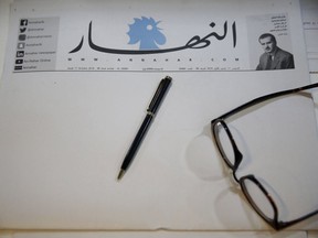A copy of a blank published An-Nahar newspaper, on a journalist's desk at the paper's headquarters, in downtown Beirut, Lebanon, Thursday, Oct. 11, 2018. Lebanon's leading newspaper has published a blank issue as a strong protest against the paralysis in the country and politicians' inability to form a government.