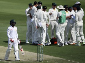 Pakistan's Muhammad Hafeez leaves after being dismissed by Australia's Mitchell Starc during their test match in Abu Dhabi, United Arab Emirates, Tuesday, Oct. 16, 2018.