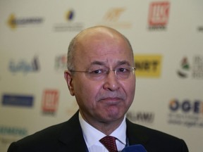 In this Wednesday, March 28, 2018 picture, Barham Salih speaks to reporters in Baghdad, Iraq. Iraqi state TV says parliament has elected the veteran Kurdish politician as the country's new president, a step toward forming a new government.