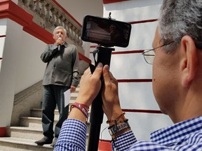 This July 14, 2018 photo shows Cesar Yanez, advisor to Mexican President-elect Andres Manuel Lopez Obrador, wearing a Rolex watch as he films the soon to be president talking to reporters at their party headquarters in Mexico City. Asked about the watch, Yanez said that it was a gift from his soon-to-be-wife, a businesswoman.
