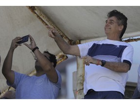 Brazil's President-elect Jair Bolsonaro watches a aerial performance by the private pilots' group "Esquadrilha do Ceu" or "Sky Squadron", at Barra beach in Rio de Janeiro, Brazil, Wednesday, Oct. 31, 2018. Bolsonaro appeared in public Tuesday for the first time as president-elect. He visited a church led by ultraconservative pastor Silas Malafaia and spoke briefly to the faithful on stage. "I am sure that I am not the most capable, but God capacitates the chosen ones," he said.