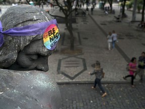 A sticker with a message that reads in Portuguese: "#Not Him", in reference to presidential frontrunner Jair Bolsonaro, is stuck to the forehead of a statue in Cinelandia square, in Rio de Janeiro, Brazil, Monday, Oct. 8, 2018. Far-right congressman Bolsonaro just missed outright victory in Sunday's vote, and will face former Sao Paulo Mayor Fernando Haddad of the leftist Workers' Party in an Oct. 28 runoff.