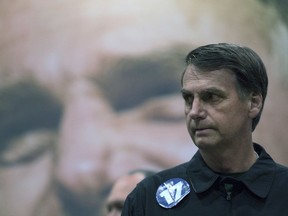 Presidential candidate Jair Bolsonaro, of the right wing Social Liberal Party arrives for a press conference in Rio de Janeiro, Brazil, Thursday, Oct. 11, 2018. Bolsonaro will face Workers Party presidential candidate Fernando Haddad in a presidential runoff on Oct. 28.