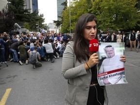 A journalist holding a poster of missing Saudi writer Jamal Khashoggi, speaks to camera near the Saudi Arabia consulate in Istanbul, Monday, Oct. 8, 2018. Khashoggi, 59, went missing on Oct 2 while on a visit to the consulate in Istanbul for paperwork to marry his Turkish fiancée. The consulate insists the writer left its premises, contradicting Turkish officials. He had been living since last year in the U.S. in a self-imposed exile, in part due to the rise of Prince Mohammed, the son of King Salman.