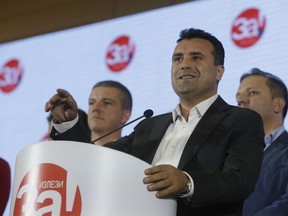 Macedonia's Prime Minister Zoran Zaev talks to members of the media during a news conference about the referendum in Skopje, Macedonia, late Sunday, Sept. 30, 2018. Zaev has described the crucial referendum on changing the small European country's name to North Macedonia and thereby pave the way to NATO membership as a clear success, despite lower than hoped for voter turnout. Zaev said he had no intention of resigning as the "vast majority" of those who voted Sunday approved the name change.