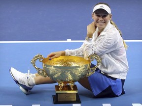 Caroline Wozniacki of Denmark poses with the winner's trophy after beating Anastasija Sevastova of Latvia in the women's singles final in the China Open at the National Tennis Center in Beijing, Sunday, Oct. 7, 2018.