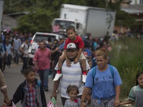 Hondurans march in a caravan of migrants moving toward the country's border with Guatemala in a desperate attempt to flee poverty and seek new lives in the United States, in Ocotepeque, Honduras, Monday, Oct. 15, 2018. The group has grown to an estimated 1,600 people from an initial 160 who first gathered early Friday in a northern Honduras city. They plan to try to enter Guatemala on Monday.