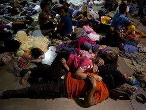 Honduran migrants sleep at an improvised shelter in Esquipulas, Guatemala, Monday, Oct. 15, 2018. The group, estimated at 1,600 to 2,000 people hoping to reach the United States, bedded down for the night in this town after Guatemala's authorities blinked first in attempts to halt their advance.