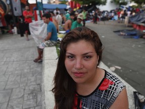 Honduran migrant Alba Rosa Chinchilla Ortiz poses for photos at a temporary shelter in the central park of Huixtla, Mexico, Tuesday, Oct. 23, 2018. Chinchilla's husband, an ex-soldier in the Honduran army has survived three attempts to kill him, Chinchilla said. Her partner of six years, he has applied for asylum in the United States and she's trying to join him and their son.