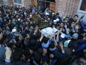 Kashmiri villagers carry the body of Uzair Mushtaq during his funeral in Kulgam 75 Kilometers south of Srinagar, Indian controlled Kashmir, Sunday, Oct. 21, 2018. Three local rebels were killed in a gunbattle with Indian government forces in disputed Kashmir on Sunday, and six civilians were killed in an explosion at the site after the fighting was over, officials and residents said.