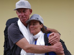 James Morrison of Tahoe, California, hugs Hilaree Nelson of Telluride, Colorado, as the pair arrived in Kathmandu, Nepal, Thursday, Oct. 4, 2018. The two American extreme skiers who overcame weather conditions, delays, equipment and oxygen issues to successfully ski down from the summit of the world's fourth-highest peak Mount Lhotse returned safely from the mountains.