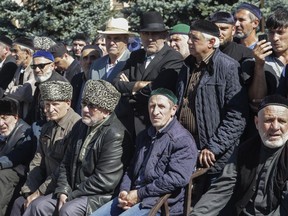 People attend a protest against the new land swap deal agreed by the heads of the Russian regions of Ingushetia and Chechnya, in Ingushetia's capital Magas, Russia, Monday, Oct. 8, 2018. Ingushetia and the neighboring province of Chechnya last month signed a deal to exchange what they described as unpopulated plots of agricultural land, but the deal triggered massive protests in Ingushetia where it was seen by many as hurting Ingushetia's interests.
