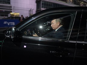 Russian President Vladimir Putin, right, drives the Aurus, or Cortege, limousine during his meeting with Egyptian President Abdel-Fattah el-Sissi at the Sochi Autodrom circuit in Sochi, Russia, Wednesday, Oct. 17, 2018.