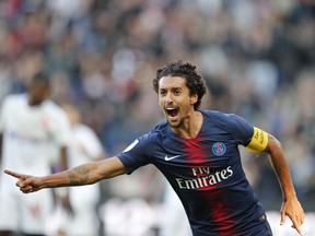 PSG's Marquinhos celebrates after scoring his side's opening goal during the French League One soccer match between Paris-Saint-Germain and Amiens at the Parc des Princes stadium in Paris, France, Saturday, Oct. 20, 2018.