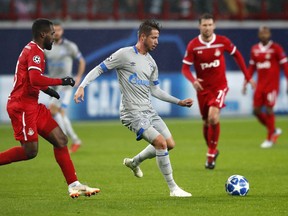 Schalke's forward Mark Uth, centre, controls the ball during the Champions League Group D soccer match between Lokomotiv Moscow and FC Schalke 04 at the Lokomotiv Stadium in Moscow, Russia, Wednesday, Oct. 3, 2018.
