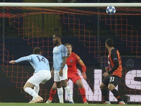 Manchester City Aymeric Laporte, left, scores his side's opening goal during the Group F Champions League soccer match between FC Shakhtar Donetsk and Manchester City at the Metalist Stadium in Kharkiv, Ukraine, Tuesday, Oct. 23, 2018.