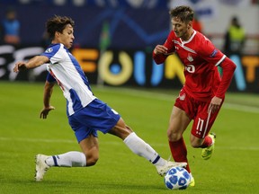 Porto Oliver Torres, left, and Lokomotiv's Anton Miranchuk challenge for the ball during the Group D Champions League soccer match between Lokomotiv Moscow and FC Porto at the Lokomotiv Stadium in Moscow, Russia, Wednesday, Oct. 24, 2018.