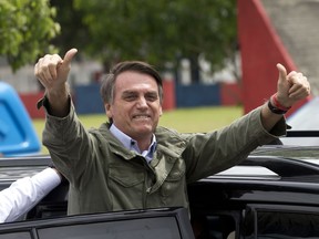 Jair Bolsonaro, presidential candidate with the Social Liberal Party, gives a thumbs up after voting in the presidential runoff election in Rio de Janeiro, Brazil, Sunday, Oct. 28, 2018. Bolsonaro is running against leftist candidate Fernando Haddad of the Workers' Party.