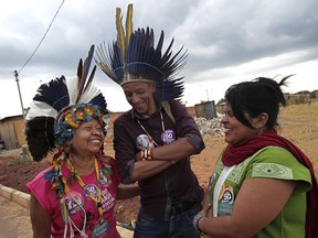 In this Sept. 15, 2018 photo, indigenous candidates Junior Xukuru, center, Airy Gaviao, left, and Sonia Guajajara, with the Socialism and Liberty Party, visit before holding a campaign rally in the Ceilandia neighborhood of Brasilia, Brazil. The tiny Socialism and Liberty Party has little chance of winning more than a small share of seats in Congress and at state levels.