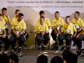 File - In this Thursday, Sept. 6, 2018, file photo, members of the Wild Boars soccer team laugh during a media conference. After receiving a healthy dose of press runs in Thailand, the 12 boys and their soccer coach who were trapped in a flooded cave for almost three weeks are ready to take the show on the road as they are scheduled to make appearances in north and south America later this week, officials said.