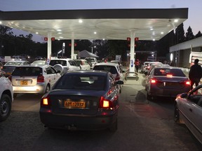Motorists wait to fill up their tanks at a fuel station in Harare, Tuesday, Oct, 9, 2018. As Zimbabwe plunges into its worst economic crisis in a decade, gas lines are snaking for hours, prices are spiking and residents goggle as the new government insists that the country somehow has risen to middle income status.