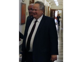 In this Tuesday, Oct. 16, 2018, Greek Foreign Minister Nikos Kotzias arrives at a cabinet meeting at the Greek Parliament in Athens. Greek Foreign Minister Nikos Kotzias has resigned, on Wednesday, Oct. 17, 2018, following a disagreement with the defense minister over the handling of a recent deal which would change Macedonia's name in exchange for Greece dropping its objections to the country joining NATO.