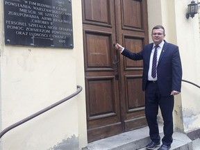 Albert Stankowski, director of the Warsaw Ghetto Museum, stands in front of the former hospital that will house the museum which is under creation and scheduled to open in 2023, in Warsaw, Poland, on Friday Oct. 19, 2018. The project, first announced earlier this year, took a key step forward on Friday when Stankowski and a government official signed an agreement on a 30-year lease for the buildings that will house the museum.