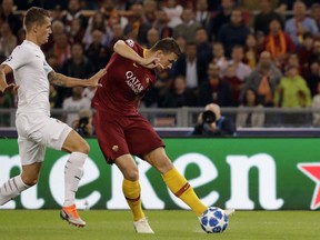 Roma forward Edin Dzeko shots go goal to score his side opening goal during the Champions League, group G soccer match between Roma and Viktoria Plzen at the Rome Olympic Stadium, in Rome, Italy, on Tuesday, Oct. 2, 2018.